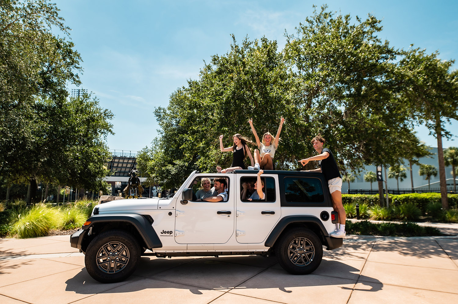 Students at UCF riding in a Jeep celebrating